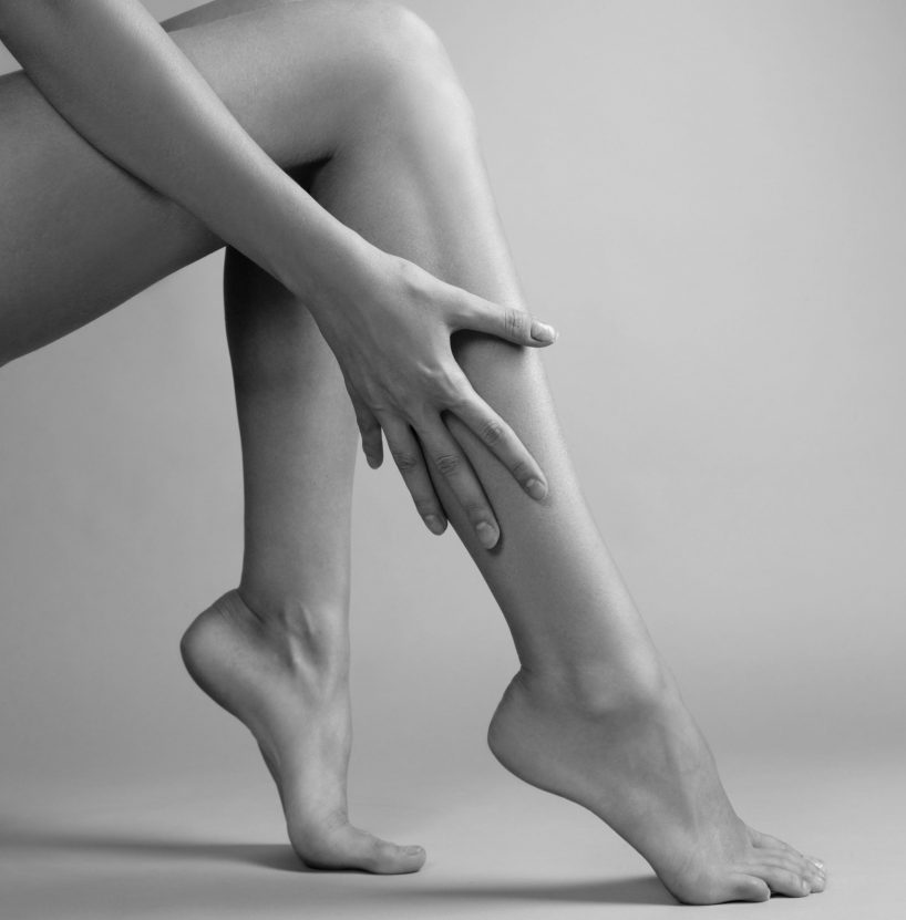 Smooth female legs on a grey background